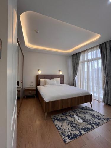 a bedroom with a large bed and a large window at Zemilo Hotel Apartment in Addis Ababa