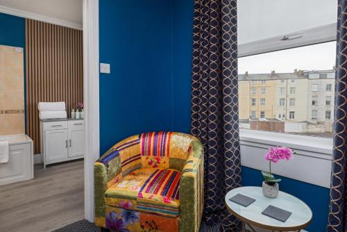 a living room with a chair and a table at Glenholme Guest House - Room Only in Scarborough