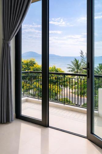 an open glass door with a view of the ocean at NOAM Stay - Sea Corner in Danang