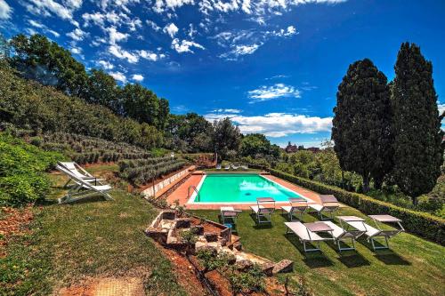 an overhead view of a swimming pool with chairs and trees at Borgo Grondaie in Siena