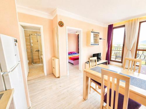 a kitchen and dining room with a table and a refrigerator at Harmony Dream Island 9 Private Apartment 618 in Sunny Beach