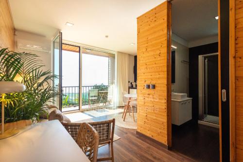 a room with a view of the balcony of a house at Ericeira Coxos Beach Lodge in Santo Isidoro