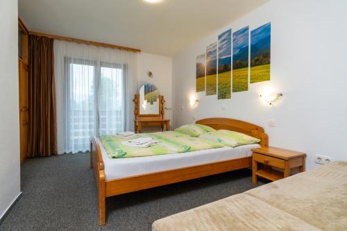 a bedroom with two beds and a window at Bed & Breakfast Hisa Resje in Bohinj