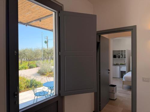 a door to a room with a view of a patio at Borgo Cucumo by MONHOLIDAY in Castellana Grotte