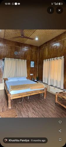 a bedroom with a bed in a wooden room at Ashaya Agro Farms in Umberpāda