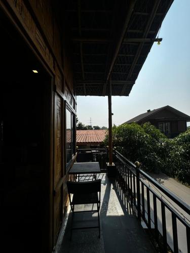 a balcony with a table and chairs on a building at Ashaya Agro Farms in Umberpāda