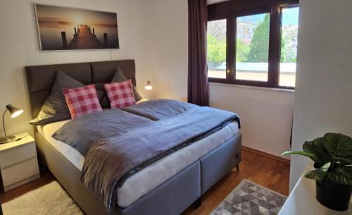 a bedroom with a large bed with red pillows at Ferienhaus Grüne Oase in Bar