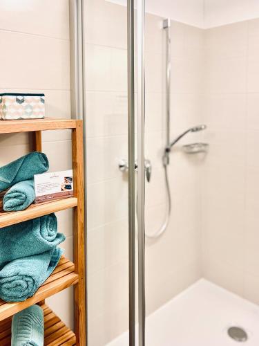 a bathroom with a shower and towels at Haus Leitner in Attersee am Attersee