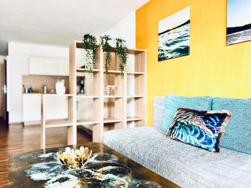 a living room with a blue couch and a table at Haus Leitner in Attersee am Attersee