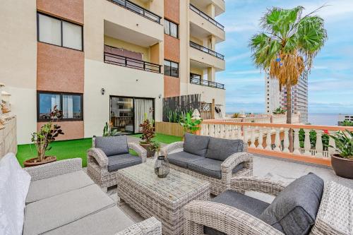 a patio with wicker furniture and a balcony at Paraiso Terrace Suite in Playa Paraiso
