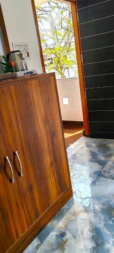 a kitchen with a wooden cabinet in a room at ayodhya homestay in Faizābād