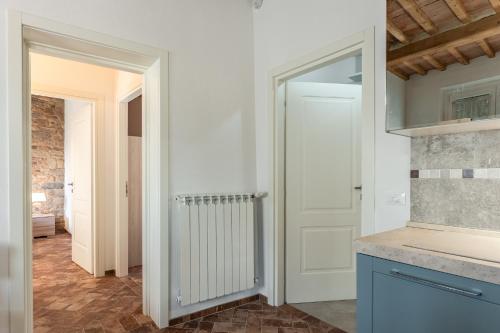 a kitchen with a white door and a counter at Casa Loretta Vicopisano in Vicopisano