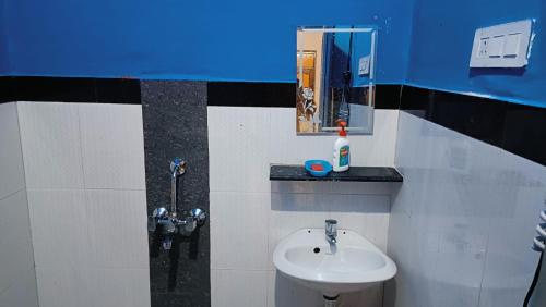 a bathroom with a sink and a mirror at Divine Blessings Banquet and Hotel in Prayagraj