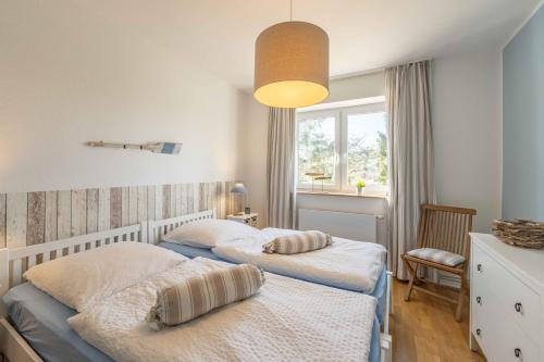 a bedroom with two beds and a window at SEASIDE APARTMENTS - LIGHTHOUSE in Eckernförde