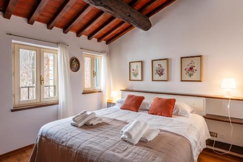 a bedroom with a large bed with two pillows on it at Mordini Loft - 3 Bedrooms - Lucca in Lucca