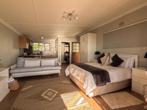 a bedroom with a large bed and a couch at Winford Manor in Murdoch Valley