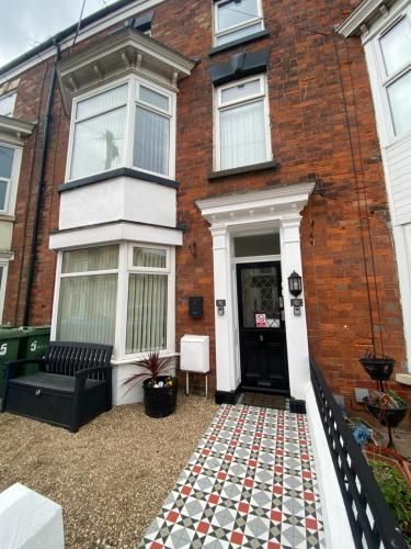 a house with a checkered floor outside of it at Rosie’s rest in Bridlington