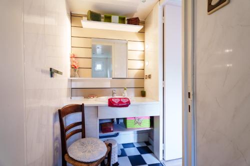 a small bathroom with a sink and a mirror at Gîte forestier du Moulin - 10 pers in Raon-sur-Plaine