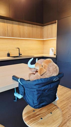 a stuffed elephant sitting in a bag in a kitchen at BLACKWOOD Kitchen in Bratislava