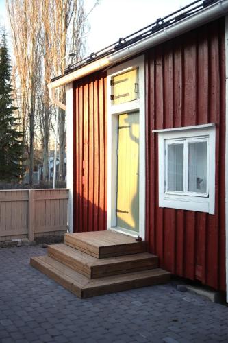 a red house with stairs and a window at Captains Cabin, Old Town, Kokkola in Kokkola