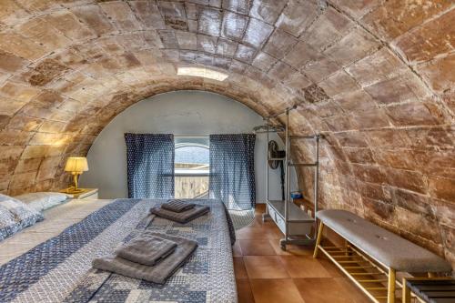a bedroom with a bed in a brick wall at Loft Calella de Palafrugell in Calella de Palafrugell