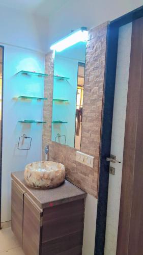 a bathroom with a sink and a mirror at Tejas 4 Bhk Villa in Pune
