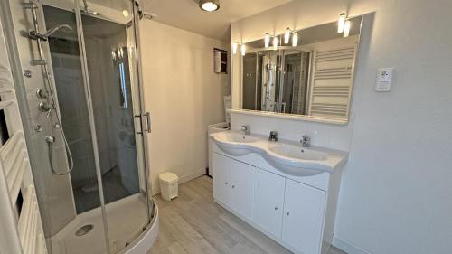 a bathroom with a shower and a sink and a mirror at La couze in Razès