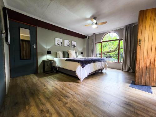 a bedroom with a bed and a large window at 440@Brooklyn in Pretoria