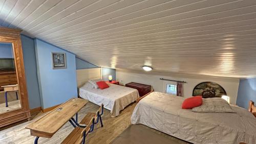 a bedroom with two beds in a room with blue walls at La couze in Razès