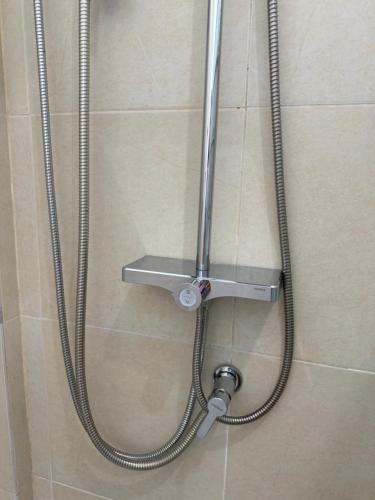 a shower in a bathroom with a hose at Laydee Resort in Chumphon