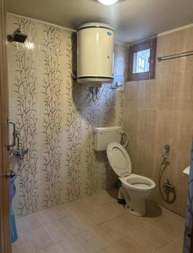a bathroom with a toilet and a shower at Hotel imroz in Srinagar