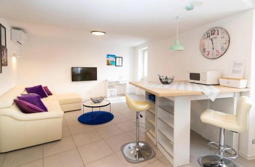 a living room with a couch and a table at DeLuxe Afrodita Apartment in Rovinj