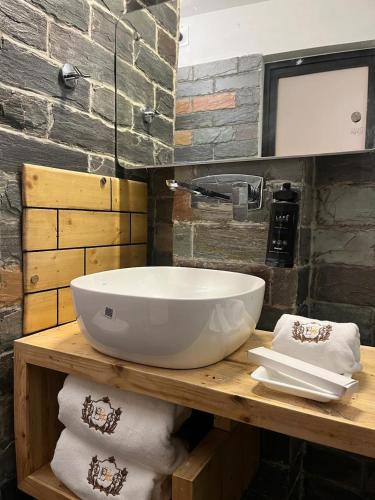 a bathroom with a sink and towels on a counter at Evri Hotel & Resorts in Lava
