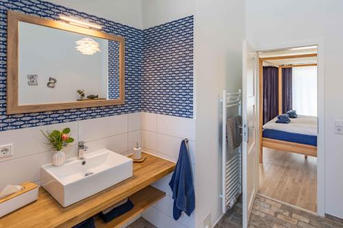 a bathroom with a sink and a mirror at SEASIDE APARTMENTS - BEACHHOUSE SKY in Eckernförde