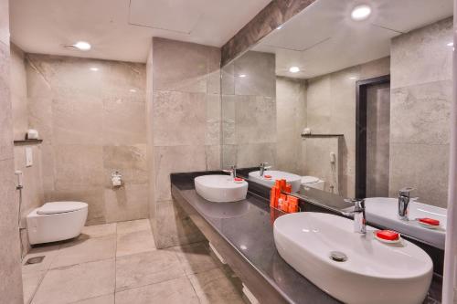 a bathroom with two sinks and a toilet at Avari Boutique Gujranwala in Fattu Mand
