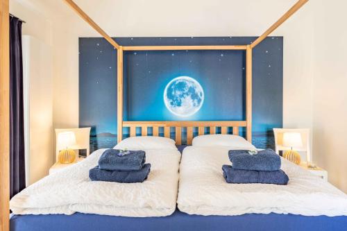 a bedroom with two beds with blue towels on them at SEASIDE APARTMENTS - BEACHHOUSE SKY in Eckernförde