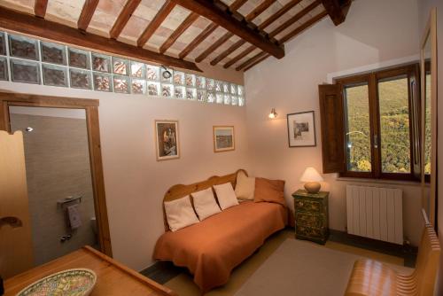 a bedroom with a bed in a room with a window at La Torretta Historical Home in Casperia