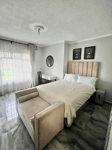a bedroom with a large bed and a desk at The Savannah Escape in Norton