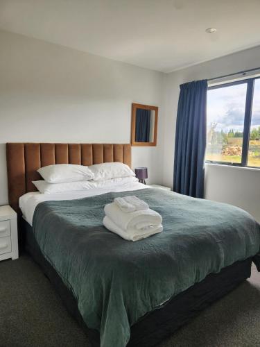 a bedroom with a bed with two towels on it at Twizel getaway in Twizel