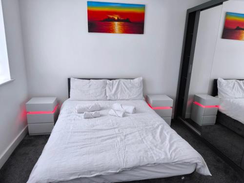 a bedroom with a white bed with two pillows on it at Teddy's in Immingham