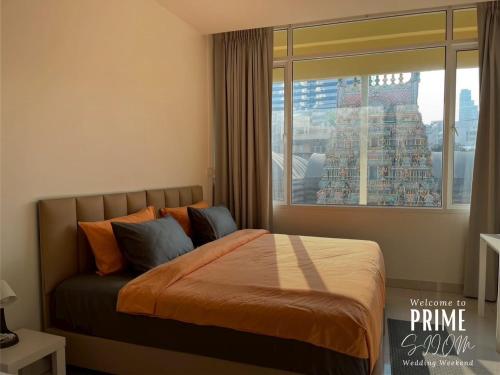 a bedroom with a bed with a large window at Prime Silom in Bangkok