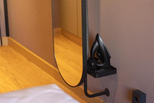 a phone hanging on a wall in a room at Scandic Stuttgart Europaviertel in Stuttgart