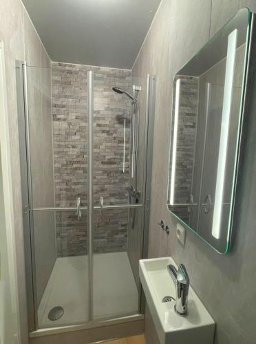 a bathroom with a shower and a sink at Outdoors Holten - Forest Cabin in Holten