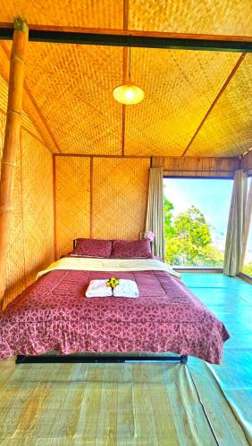 a large bed in a room with a large window at Mon Ngo misty haven B3 in Ban Nong Chaeng