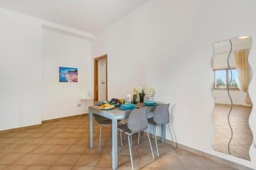 a dining room with a table and chairs at Residence Argentiera in Miniera dellʼArgentiera