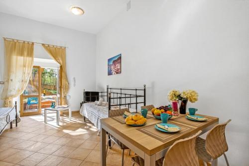 a dining room with a table with fruit on it at Residence Argentiera in Miniera dellʼArgentiera