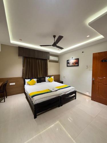 a bedroom with a bed and a ceiling at The Royal Samrat Newly renovated in Pune