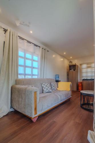 a couch in a living room with a window at Mayas Stay in Busia