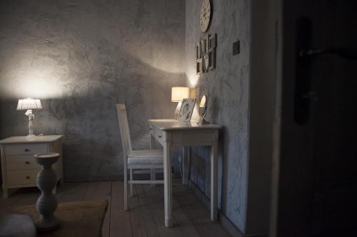 a room with a desk and a chair and a lamp at Apartments Rose Garden in Děčín