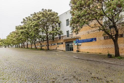 an empty street in front of a brick building at HI Parque das Nações – Pousada de Juventude in Lisbon
